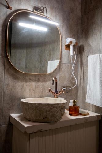 a bathroom with a stone sink and a mirror at Ana Talia House in Mardin