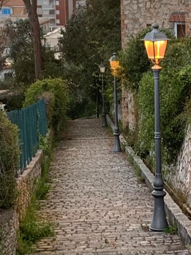 a cobblestone street with street lights on it at La Conchiglia in Sperlonga
