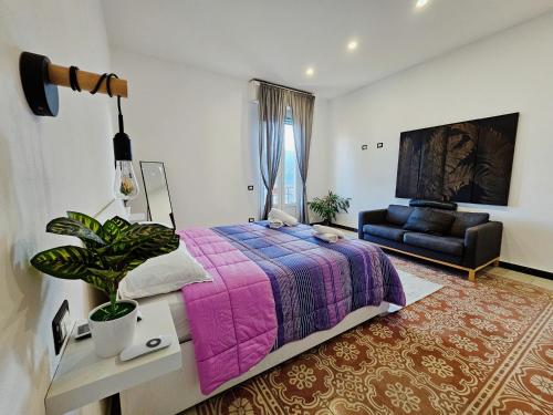 a bedroom with a purple bed and a couch at The view in La Spezia