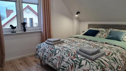 a bedroom with a bed with towels on it at Mała Izerka in Mirsk