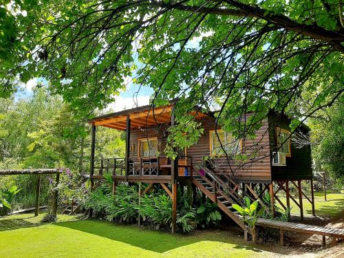 a wooden cabin with a staircase leading up to it at Delta tigre "Peperina Gambado" in Tigre