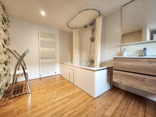 a kitchen with a counter and a wooden floor at Appart4you in Namur