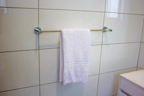 a towel hanging on a towel rack in a bathroom at 16 Elizabeth Place - Luxury Apartments, Free Wi-Fi in Midrand