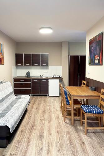 a kitchen and dining room with a table and a bed at Marina Boszkowo in Boszkowo-Letnisko