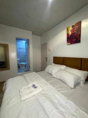 a white bed with a towel on it in a room at Mph 4 in Lagos