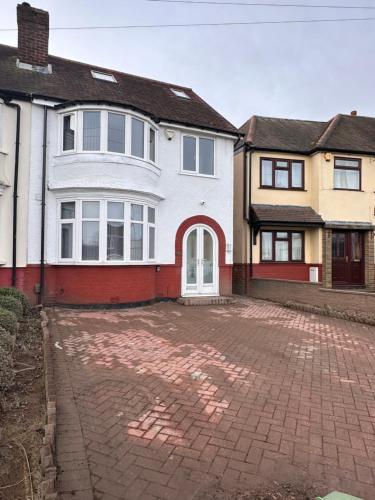 a large white house with a brick driveway at R5 - Private Studio self contained En-suite Room in Newly renovated house in Birmingham B62 in Quinton