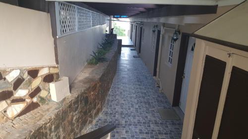 an empty hallway of a building with a tile floor at Sunset Gardens Guesthouse in Charlotte Amalie
