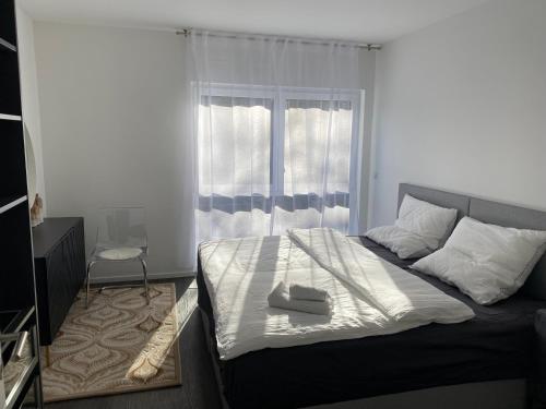 a bedroom with a large bed with a window at Valley of Business Frankfurt-West - Apartment Nº2 - Two-Bedroom in Hofheim am Taunus