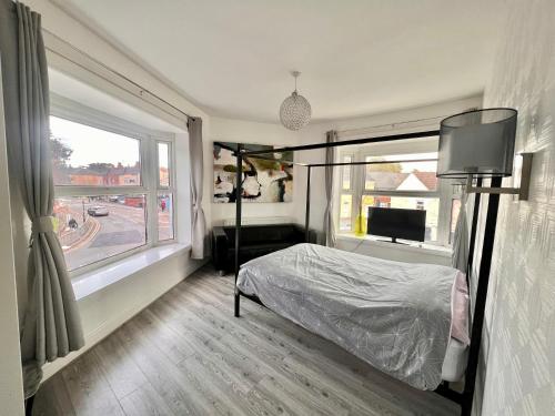 a bedroom with a bed and a large window at Lana house in Birmingham
