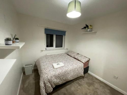 a small bedroom with a bed in a room at 231 Senwick drive in Wellingborough