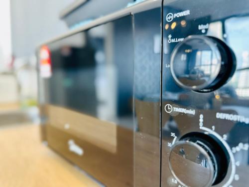 a close up of a toaster oven at New 2BR or 3BR Homey Getaway stay 7 to 10 pax at Urban Suites, Georgetown by URBAN STAYCATION LOD in Jelutong