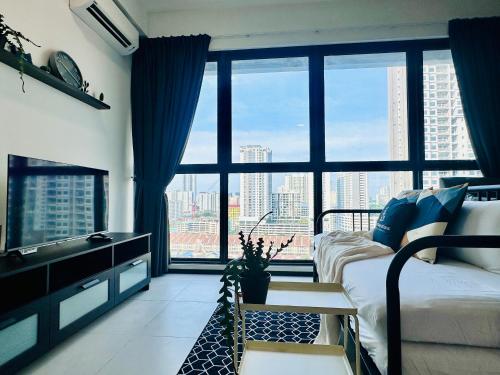 a bedroom with a bed and a large window at New 2BR or 3BR Homey Getaway stay 7 to 10 pax at Urban Suites, Georgetown by URBAN STAYCATION LOD in Jelutong
