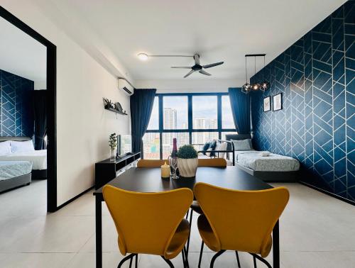 a living room with a table and two chairs at New 2BR or 3BR Homey Getaway stay 7 to 10 pax at Urban Suites, Georgetown by URBAN STAYCATION LOD in Jelutong