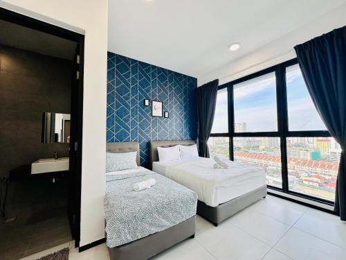 a hotel room with two beds and a window at New 2BR or 3BR Homey Getaway stay 7 to 10 pax at Urban Suites, Georgetown by URBAN STAYCATION LOD in Jelutong
