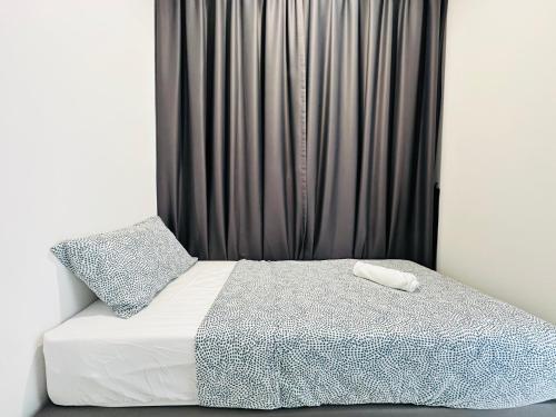 a bedroom with a bed with a black curtain at New 2BR or 3BR Homey Getaway stay 7 to 10 pax at Urban Suites, Georgetown by URBAN STAYCATION LOD in Jelutong
