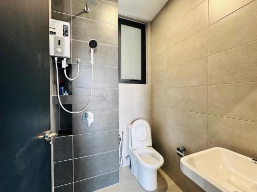a bathroom with a toilet and a sink at New 2BR or 3BR Homey Getaway stay 7 to 10 pax at Urban Suites, Georgetown by URBAN STAYCATION LOD in Jelutong