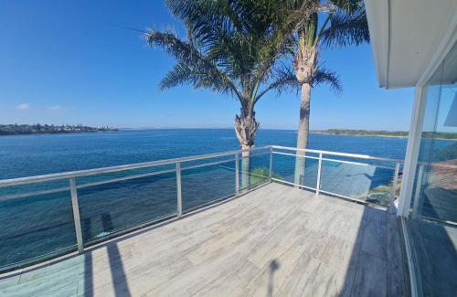 a view of the ocean from the balcony of a house at Bundeena Waterfront Pavilion in Bundeena