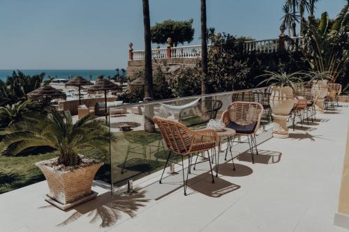 a row of chairs and tables on a balcony at Villa Soluna in Vélez-Málaga