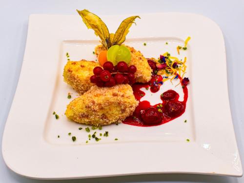 a plate with some food on a white plate at Vital- und Wellnesshotel Albblick in Waldachtal