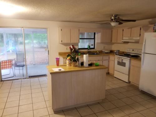 a kitchen with a counter top and a refrigerator at Pinecone Park in Wimauma