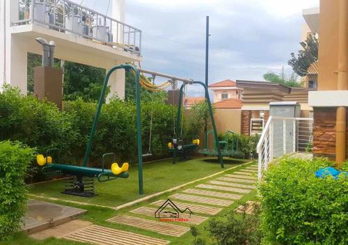 a playground in a yard next to a building at Best Pet-Friendly Condo Near Puerto Princesa Airport - B2 6Diamond in Puerto Princesa City