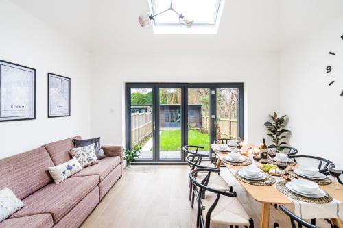 a living room with a couch and a table and chairs at Cozy 3 Bedroom Terrace Cottage in Epsom in Epsom