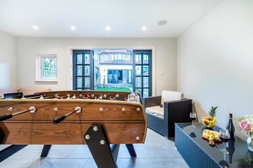 a pool table in the middle of a room at Cozy 3 Bedroom Terrace Cottage in Epsom in Epsom
