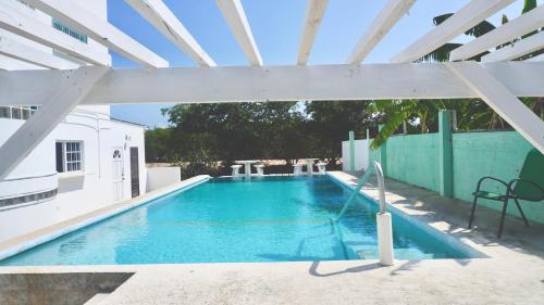 a large swimming pool with a white roof at See Belize Sea View Vacation Rentals in Belize City