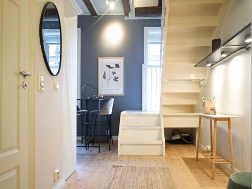 a hallway with stairs and a desk and a table at Charming and spacious apartment in Oslo