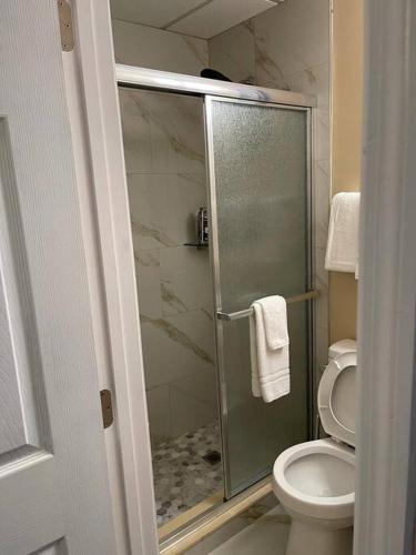 a bathroom with a toilet and a glass shower at Unforgettable Stay in Orlando 1 in Orlando