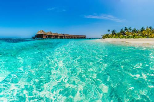 an island in the ocean next to a beach at Kandolhu Maldives in Himandhoo 