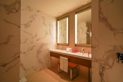 a bathroom with a sink and a mirror at THE CLOSEST building to Burj Khalifa with Fountain View in Address Opera Residence in Dubai