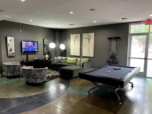 sala de estar con mesa de billar y TV en Comfortable Apartment in Dallas, en Addison