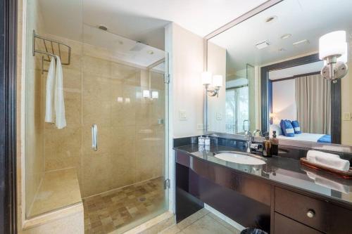 a bathroom with a shower and a sink and a mirror at Stunning Getaway w/ Private Outdoor Jacuzzi in Miami Beach