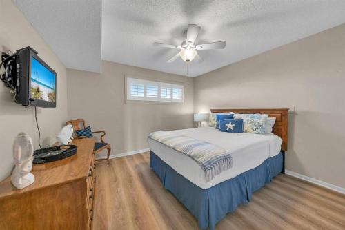 a bedroom with a bed and a ceiling fan at Islander 311 Sandy Dunes in Destin