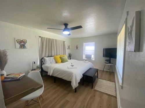 a bedroom with a large bed with yellow pillows at Walking Distance to University Mall Big Backyard in Orem