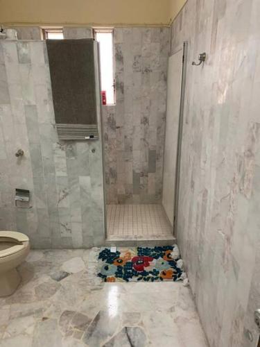 a bathroom with a shower and a toilet at La casa del cerro con vista al oceano pacifico in Mazatlán