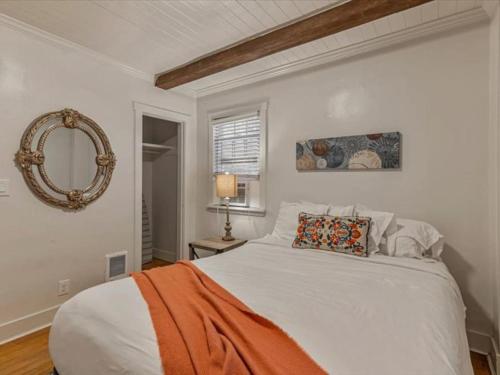 a bedroom with a white bed and a mirror at Cozy Getaway in Central Provo in Provo