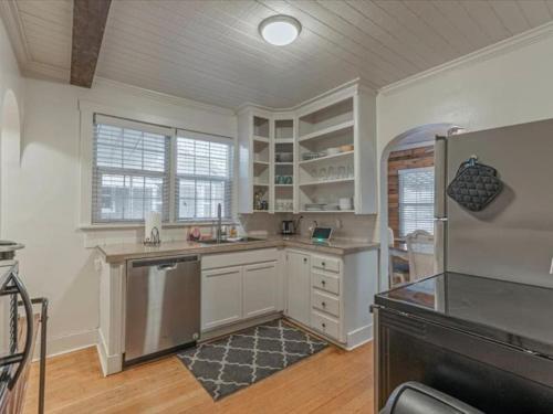a large kitchen with white cabinets and a refrigerator at Cozy Getaway in Central Provo in Provo