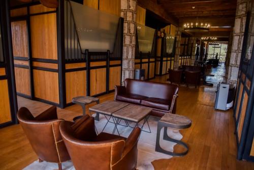 a living room with a couch and chairs and a table at Hacienda Tovares in Cadereyta de Montes