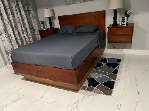 um quarto com uma cama e uma cabeceira em madeira em Seaside Escape em Wickhams