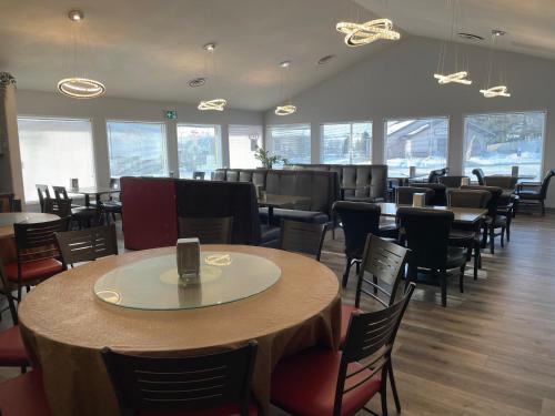a dining room with tables and chairs and windows at The 22 Hotel in Cremona