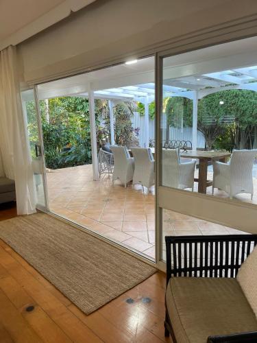 a screened in porch with chairs and a table at Watermill Beach House Estate in Kingston
