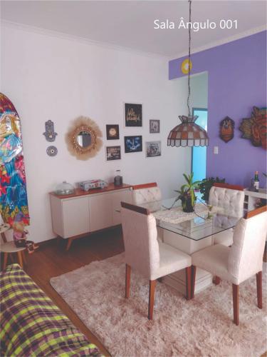 a living room with a table and chairs at Quarto Carnaval 2024 Salvador in Salvador