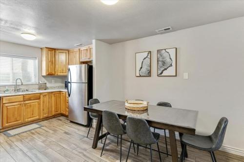 a kitchen with a table and chairs and a refrigerator at Two Kitchens Large Backyard Two Units in Springville