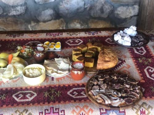 a table with a variety of food on it at Vikendice Suvo Do in Berane