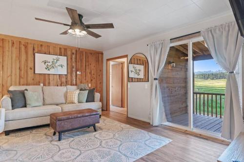 a living room with a couch and a sliding glass door at Mountain View Gem BHBungalows #2 in Custer