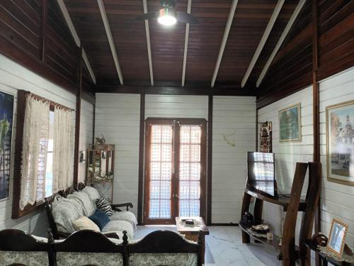 a living room with a couch and a window at Casa Agradável, 50m da Praia Freguesia do Ribeirão da Ilha in Florianópolis