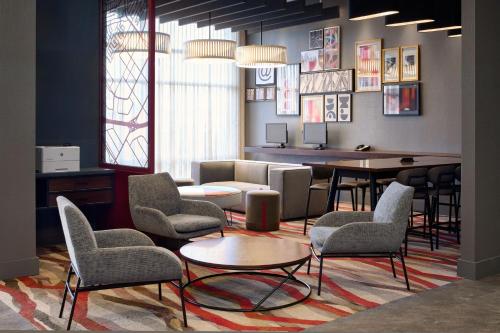 a waiting room with chairs and a table and a couch at Residence Inn by Marriott Montreal Airport in Dorval