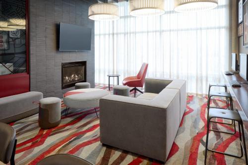 a living room with a couch and a fireplace at Residence Inn by Marriott Montreal Airport in Dorval